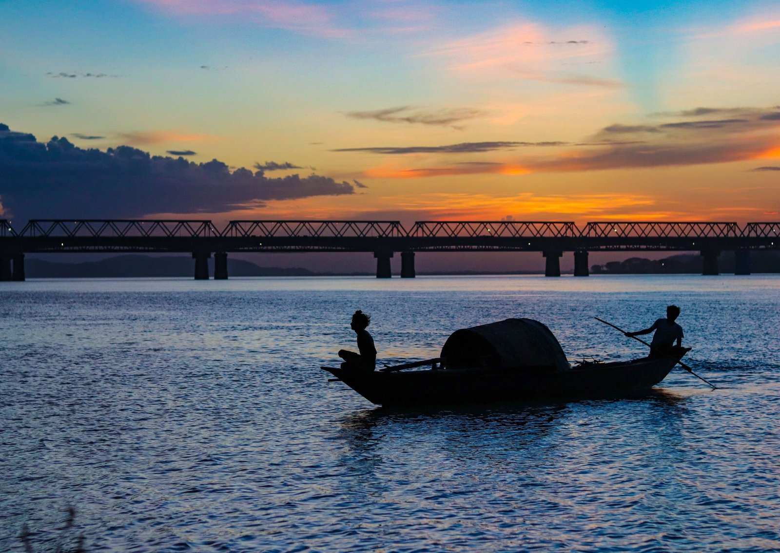 Fishermen on the Brahmaputra River at sunset, Assam