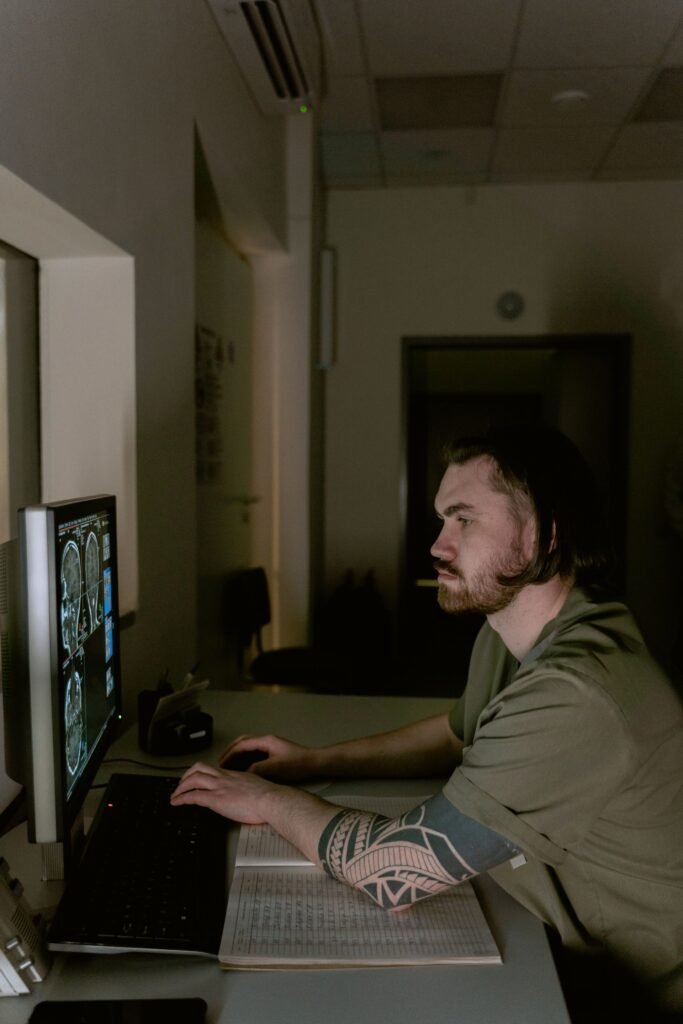 Radiologist reviewing scans on a computer monitor, representing a careful review of an overcharged hospital bill