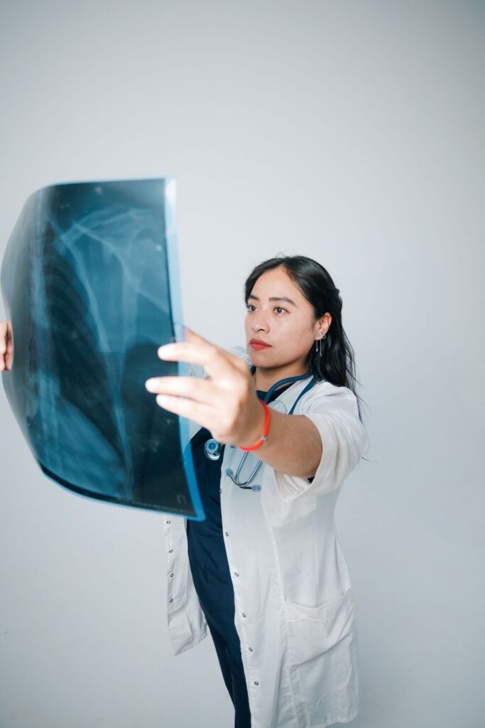 Doctor in a white coat examining a patient X-ray, representing consultations and treatment planning at hospitals in Gurgaon