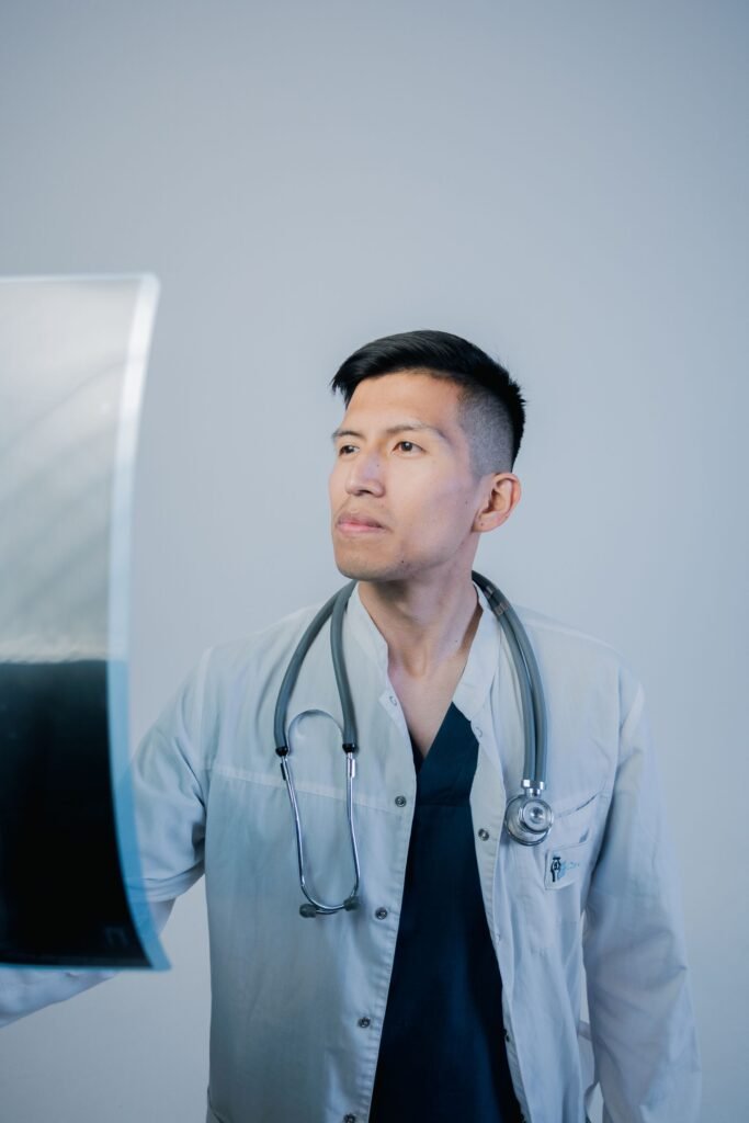 Doctor examining an X-ray in a clinic, representing medical records gathered to support a hospital bill complaint