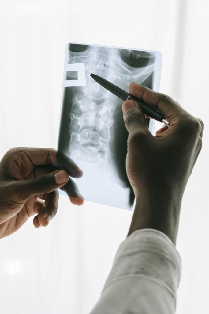 Person holding a pen and an X-ray, representing prescriptions and treatment records reviewed before buying medicines