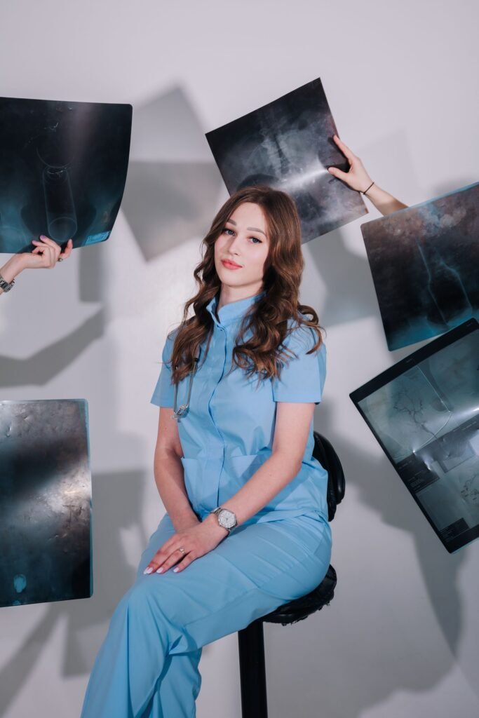 Doctor in scrubs surrounded by X-ray images, representing the monitoring and tests that make up a daily ICU bill