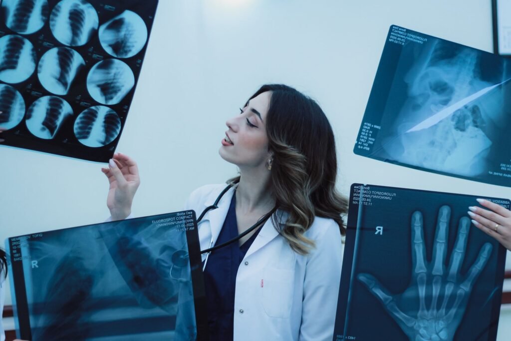 Doctor examining X-ray films in a clinic, representing the specialist consultations families plan with a medical concierge in Kochi