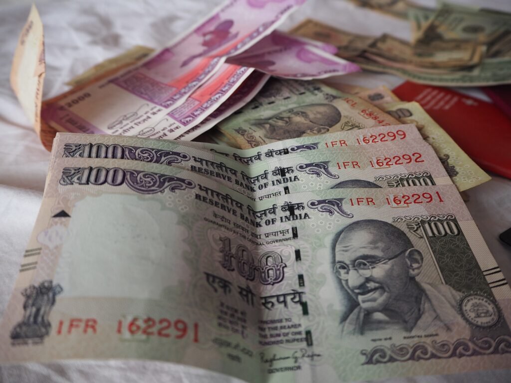 Indian 100 and 2000 rupee notes, representing the cost of treatment families may need to finance