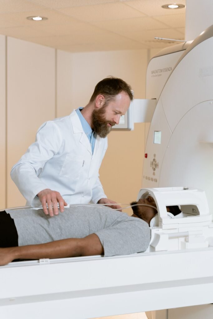 Doctor helping a patient during a scan at a modern hospital, representing medical tourism in India for international and outstation patients