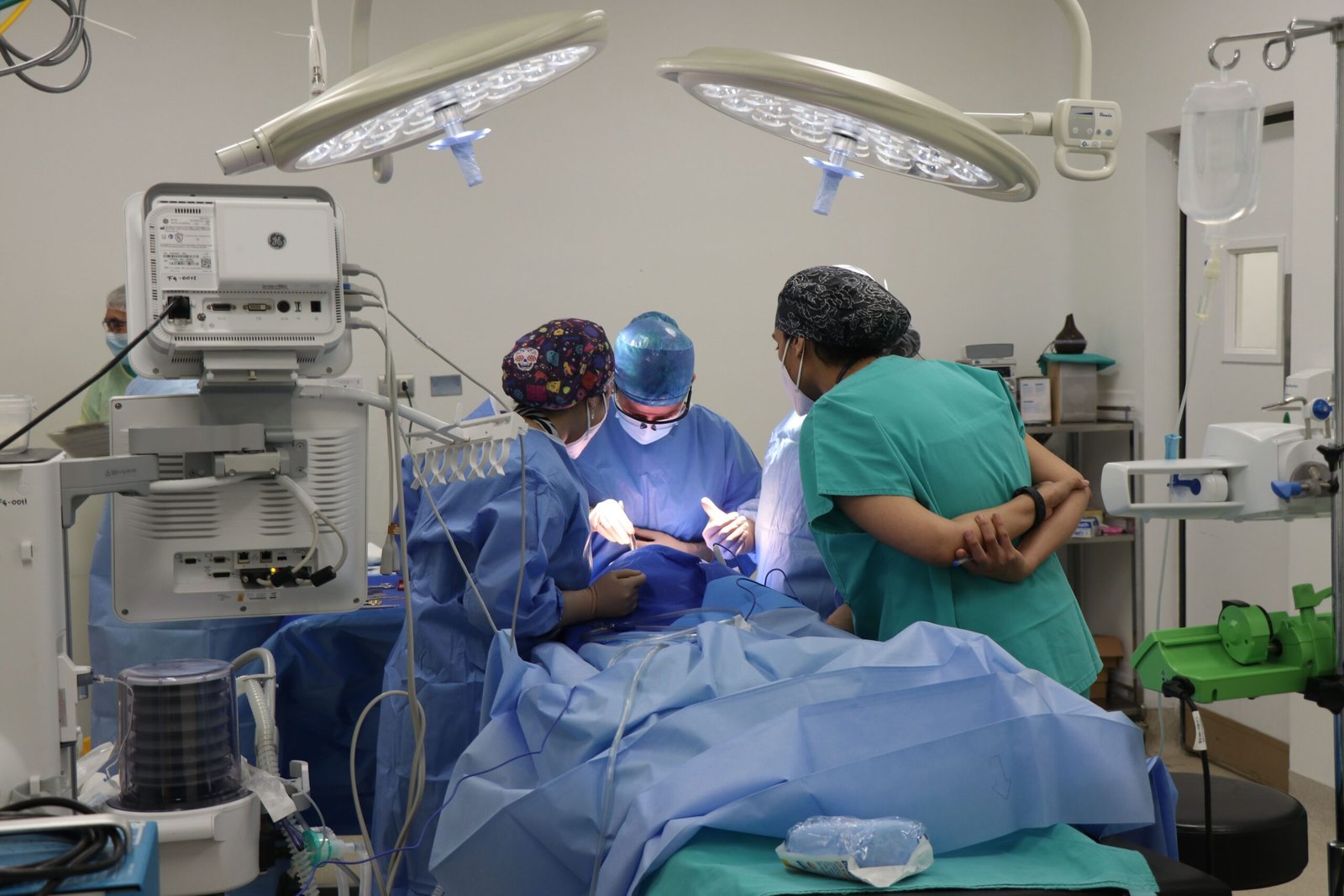 Surgical team operating in a well-equipped OR