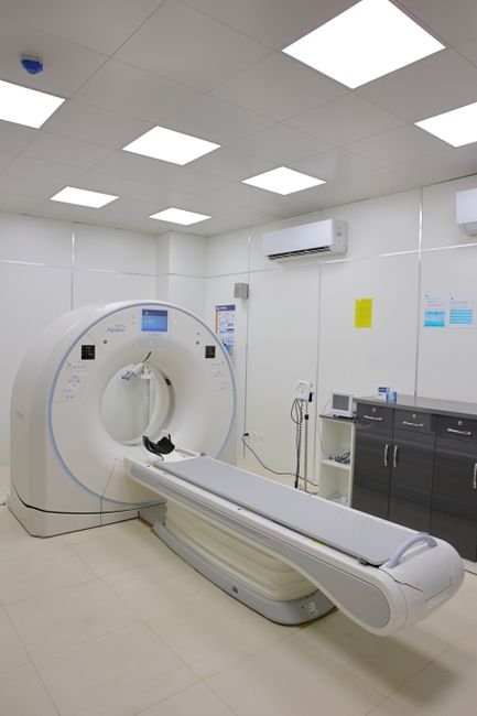 High-tech CT scanner in a bright hospital room