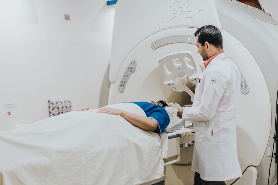 Doctor assisting a patient during an MRI examination in a hospital