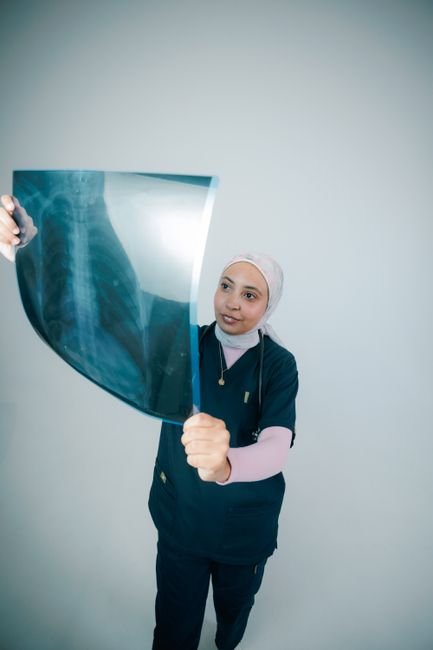 Doctor examining a chest X-ray confidently in a hospital