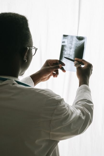 Doctor reviewing a patient case file with a pen, representing dedicated case management