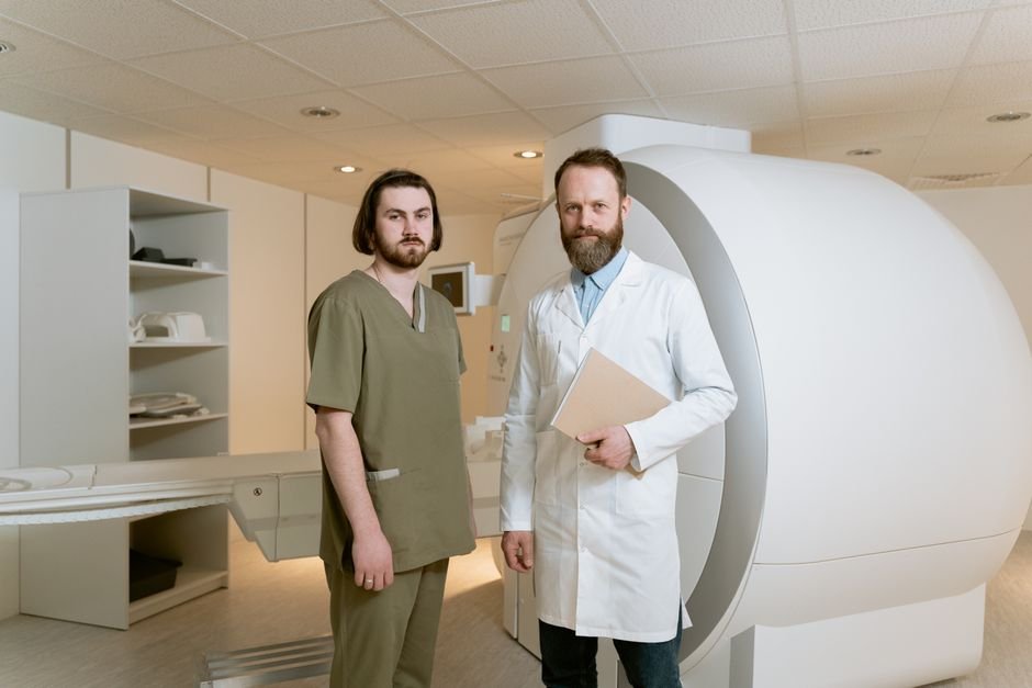 Doctors standing next to an MRI machine showcasing medical technology