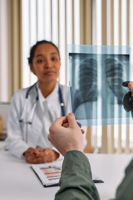 Doctor reviewing a patient's chest X-ray results during a consultation