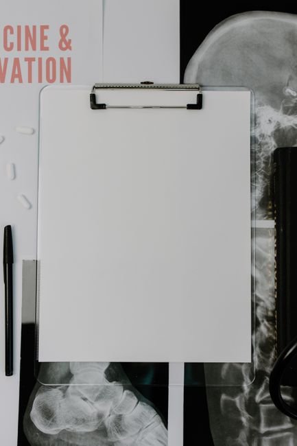 Blank clipboard with paperwork on a medical desk