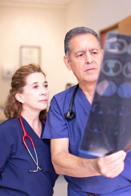 Two healthcare professionals examining an X-ray image together