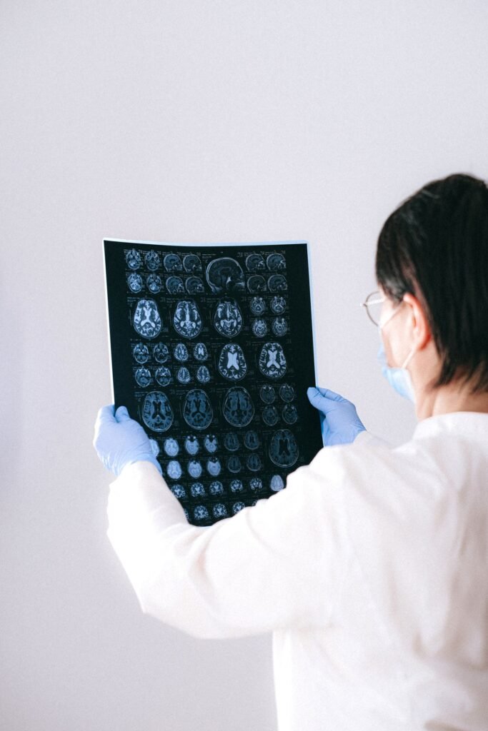 Radiologist holding and examining a detailed scan, representing hospital treatment covered under PM-JAY packages
