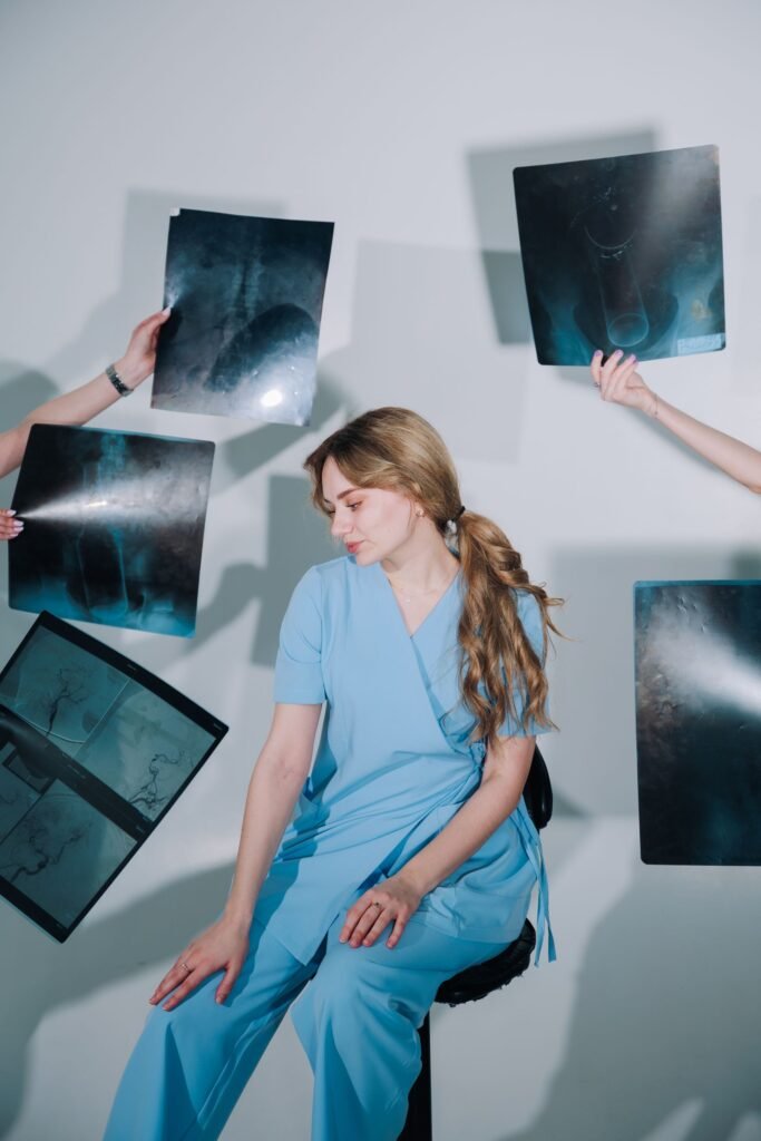 Doctor in blue scrubs examining X-rays, representing treatment items listed as inclusions or exclusions in a surgery package