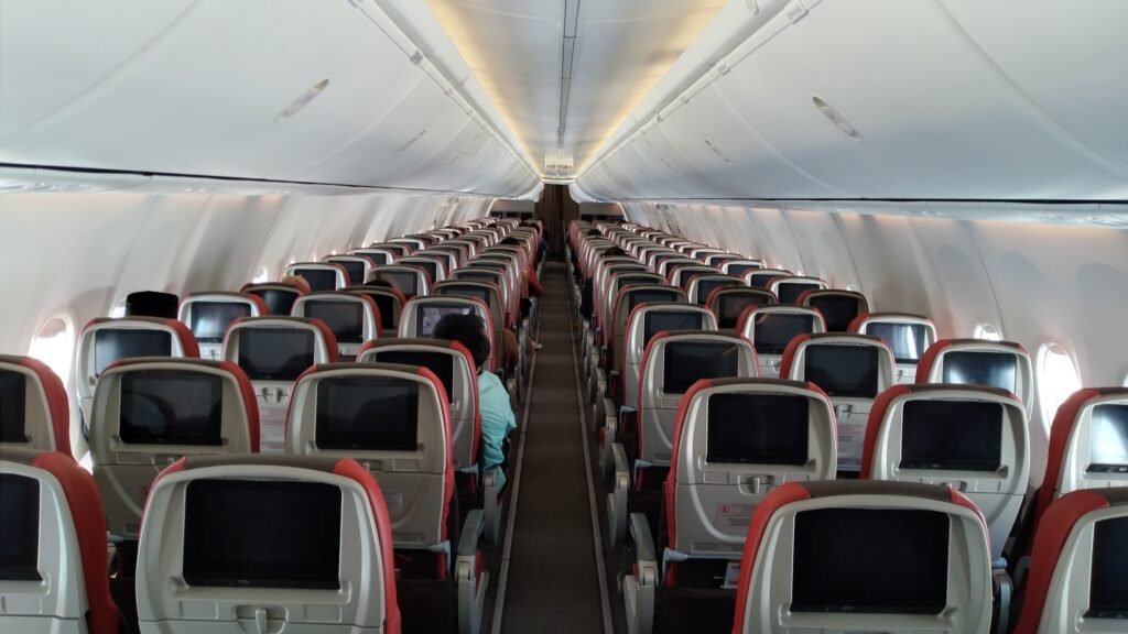Economy class aircraft cabin, where long flights after surgery need planning
