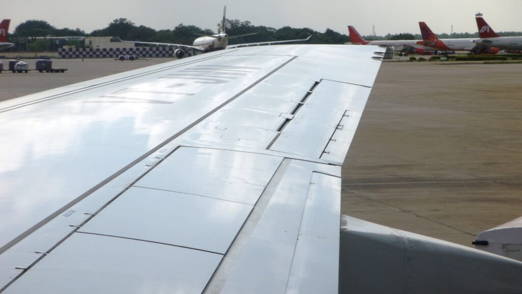 View of an aircraft wing from a passenger window during a flight home