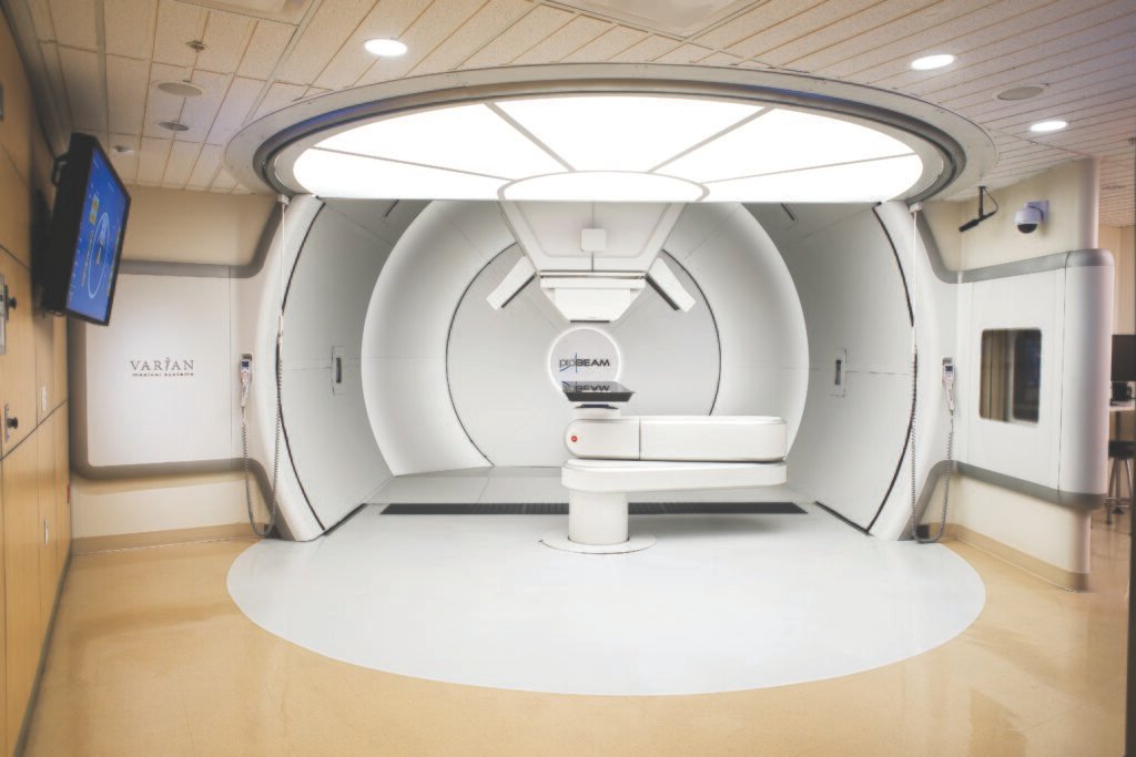 Proton therapy treatment room with a rotating gantry